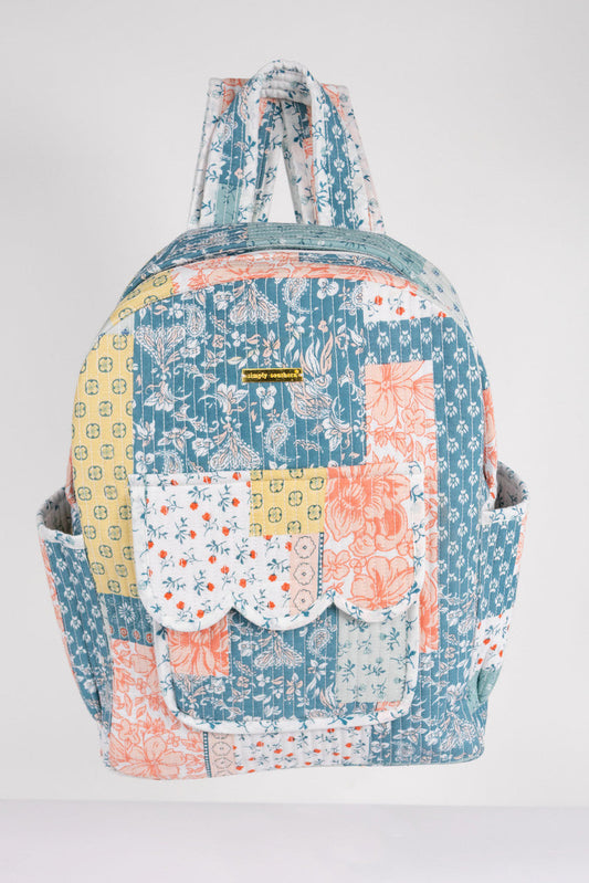 Multicolored patchwork backpack on a white background