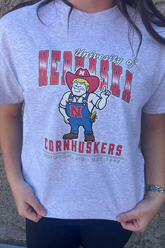 Gray t-shirt with 'University of Nebraska Cornhuskers' graphic design.