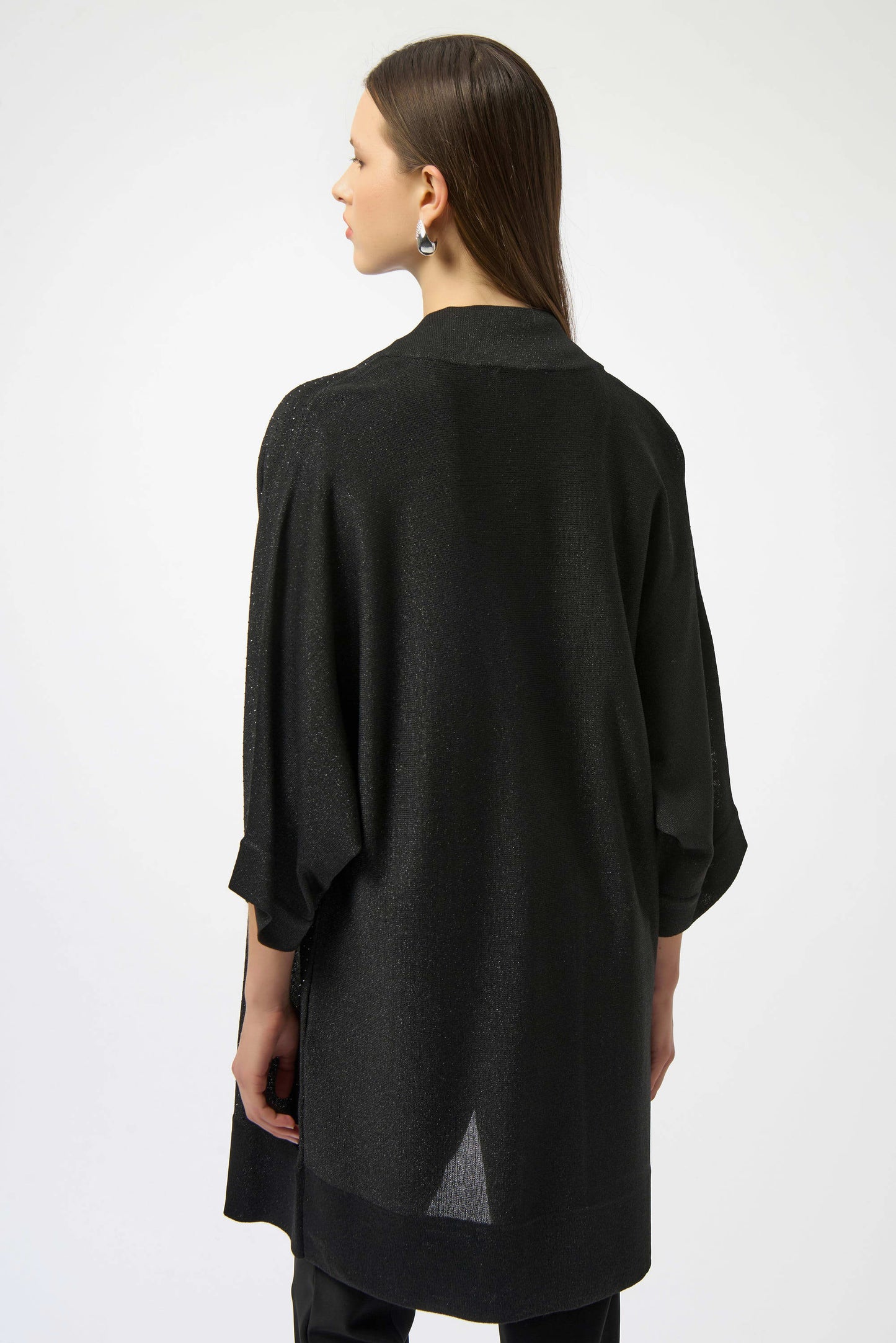 Woman wearing a black oversized shirt on a white background