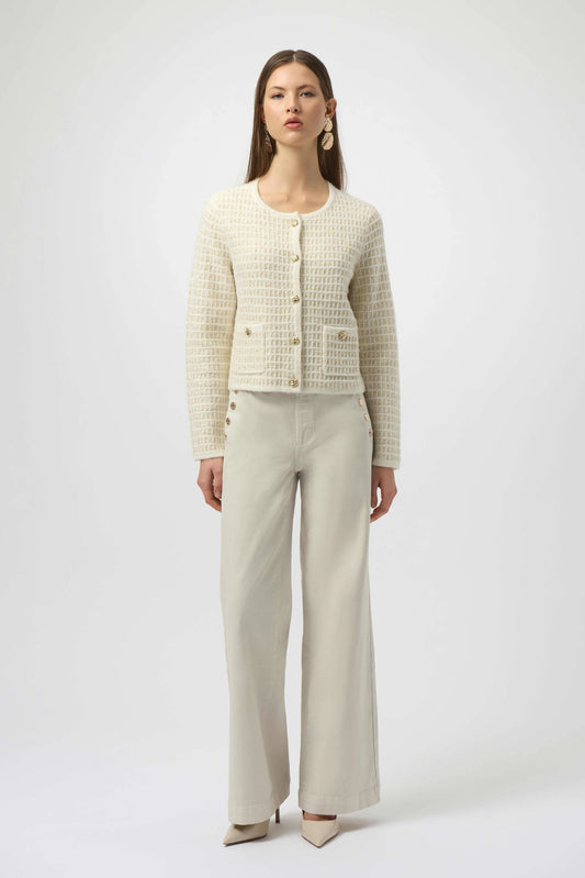 Woman wearing a beige checkered jacket and pants on a white background