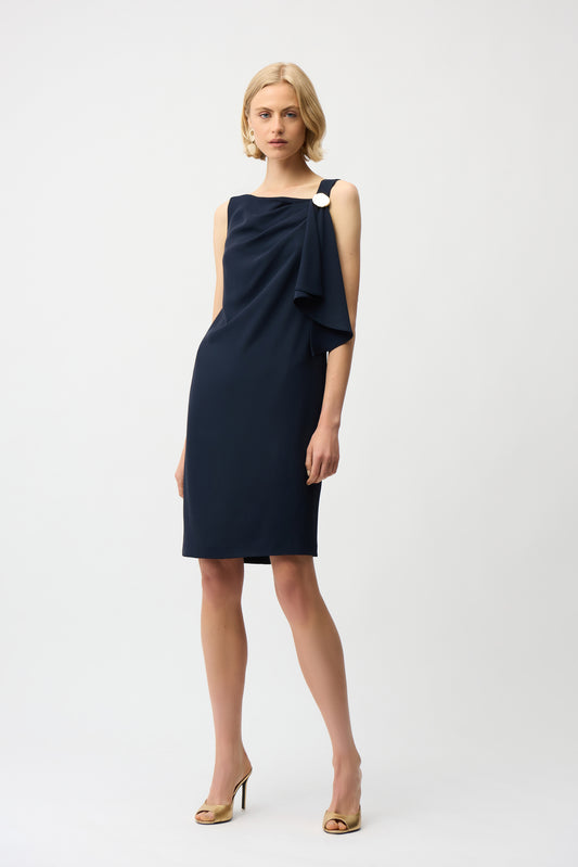 Woman wearing a navy blue dress on a white background