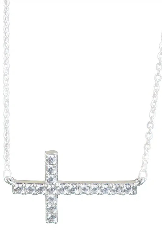 Silver cross necklace with small diamonds on a white background