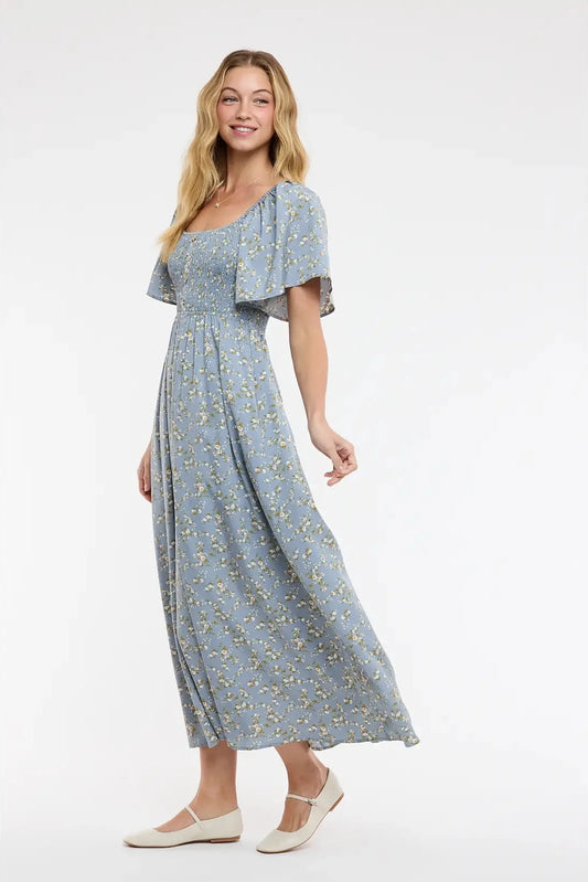 Woman wearing a blue floral dress on a white background