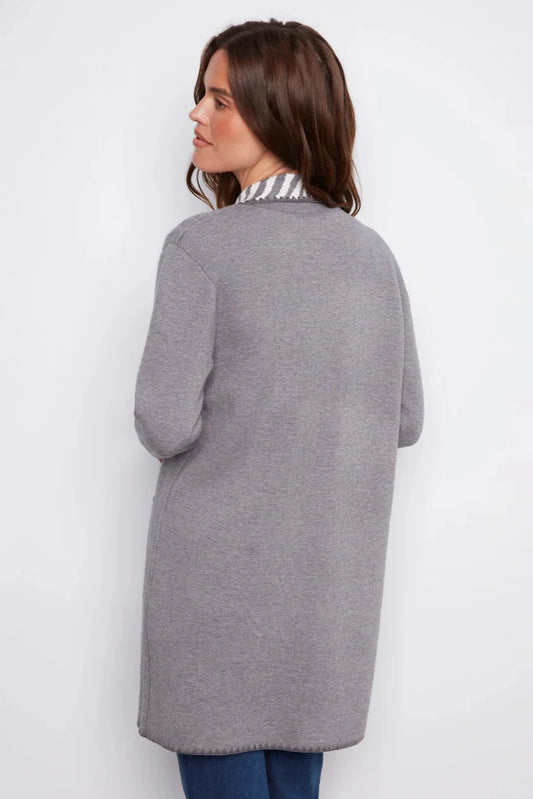 Woman wearing a gray cardigan against a white background