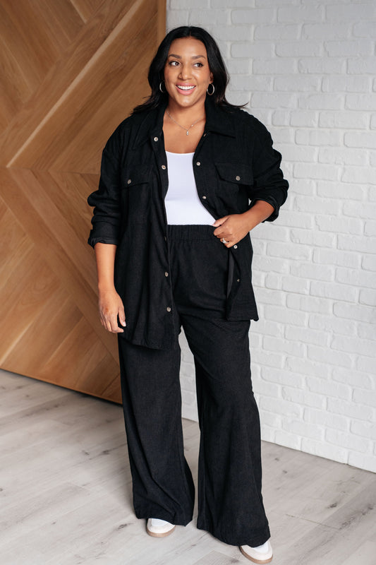 Woman wearing a black outfit with a white background