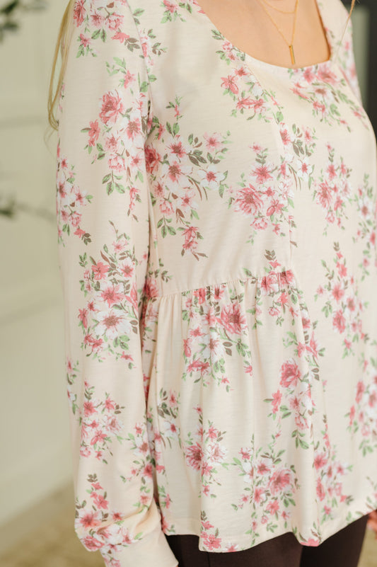 Floral-patterned long-sleeve top on a blurred background