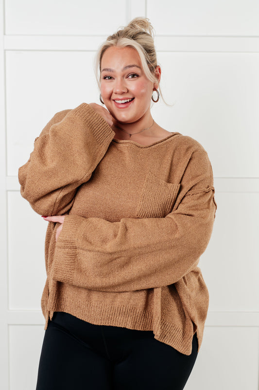 Woman wearing a brown sweater against a white background