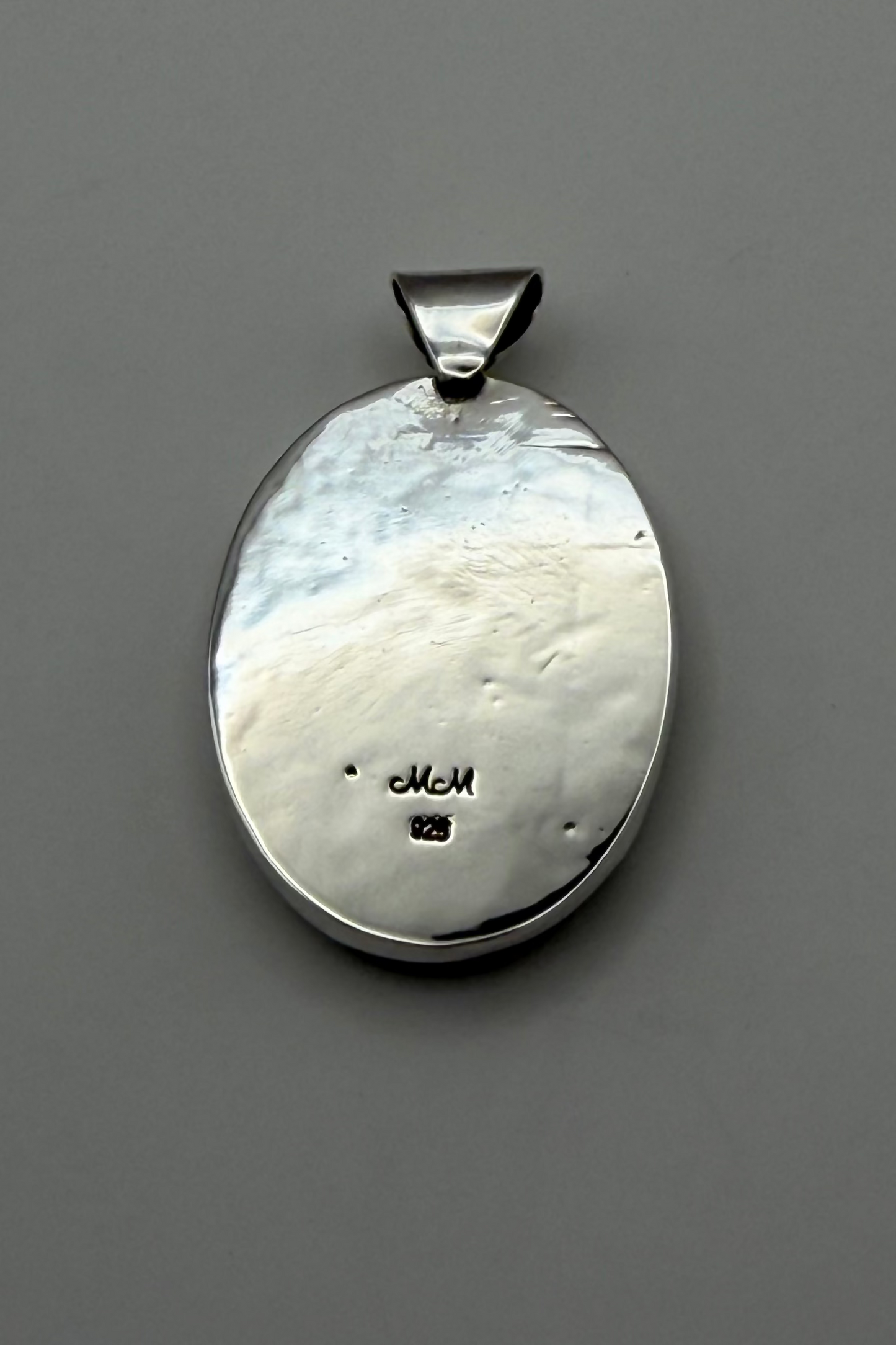 backside of pendant showing "925" stamp.
