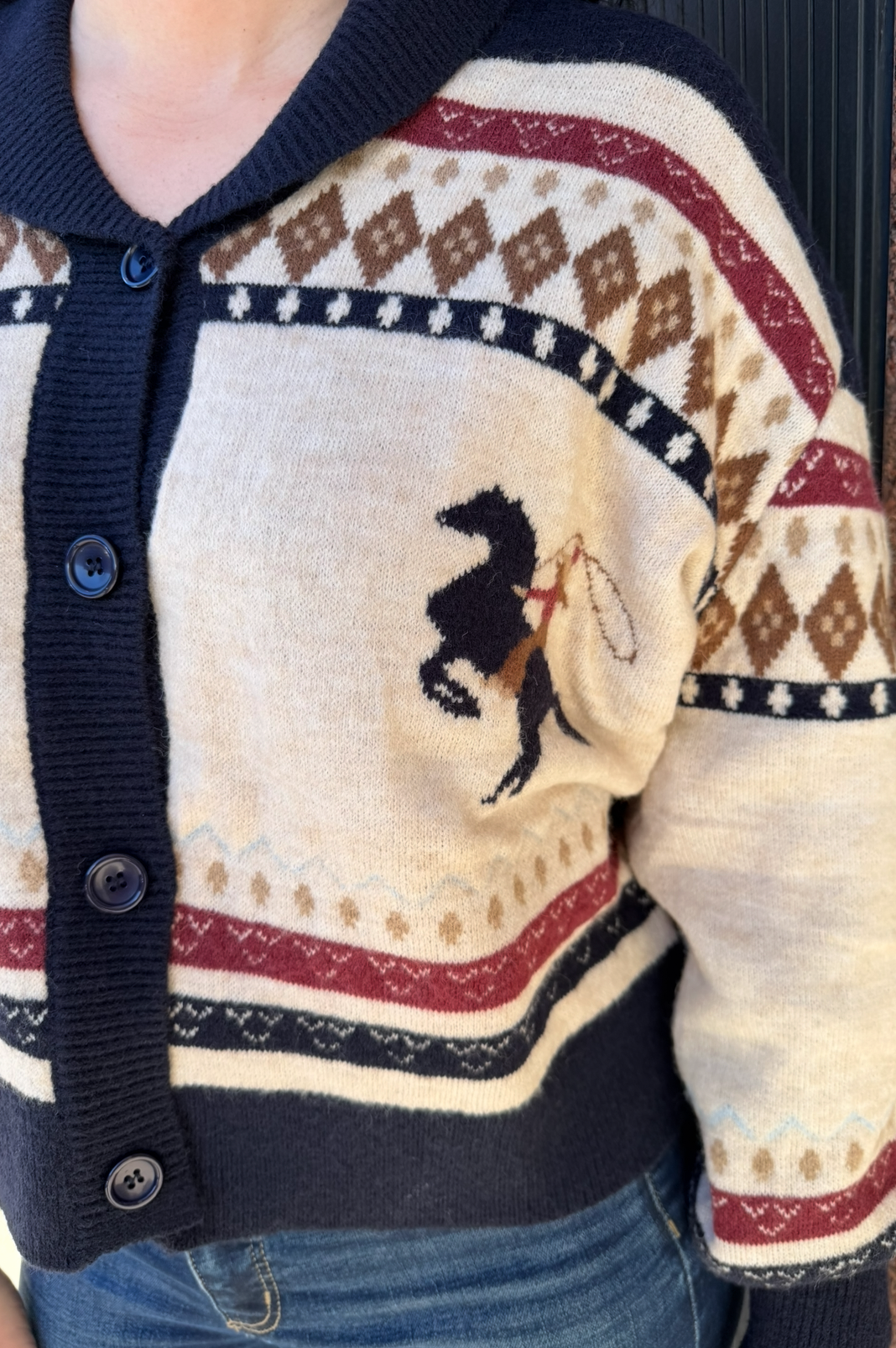 Cardigan with a pattern and logo on a plain background