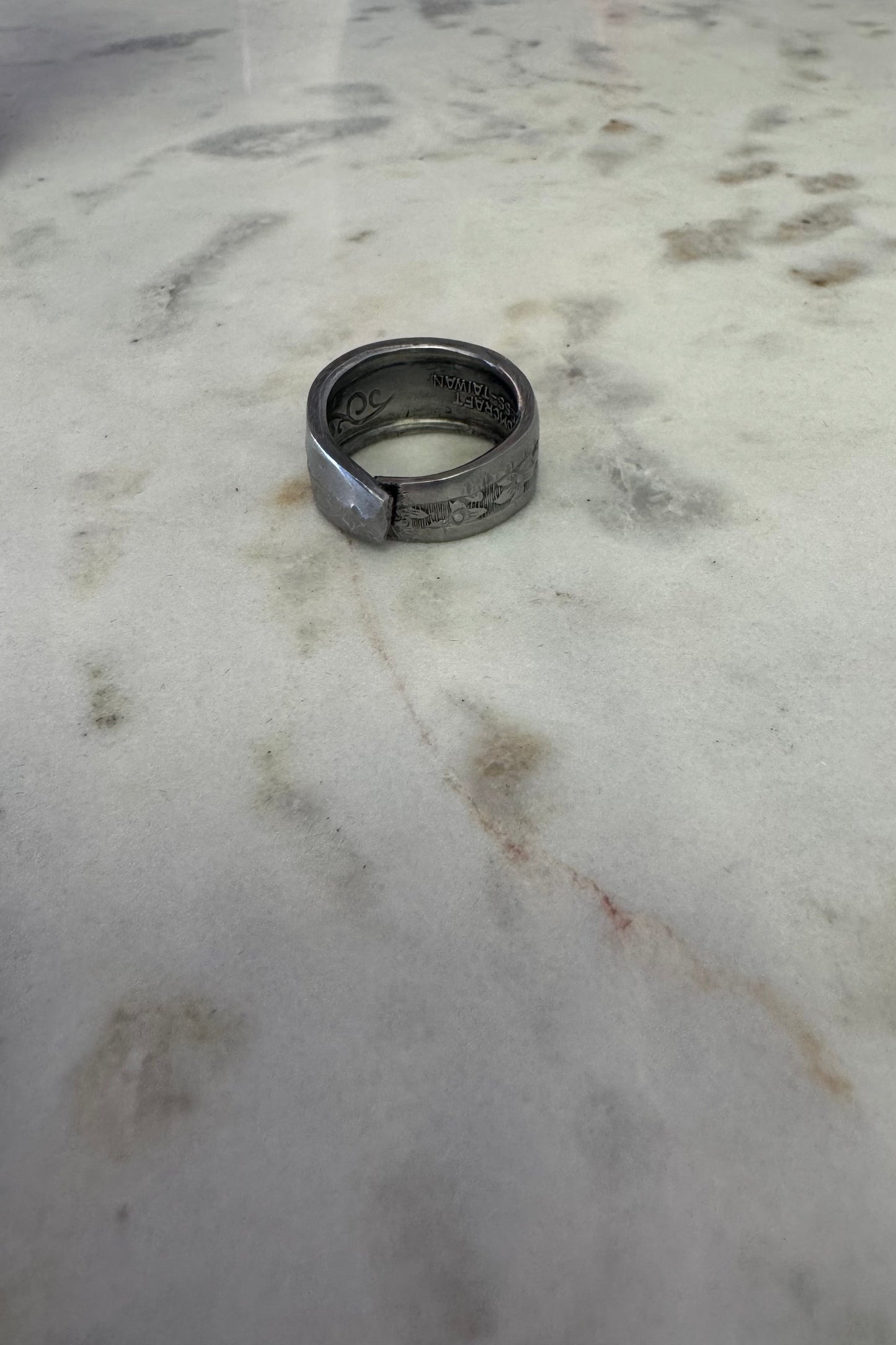 Silver ring on a marble surface