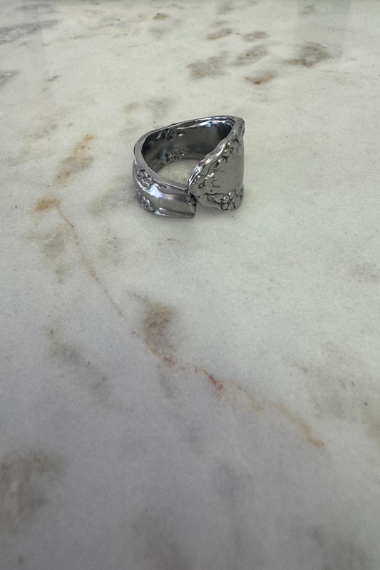 Silver ring on a marble surface