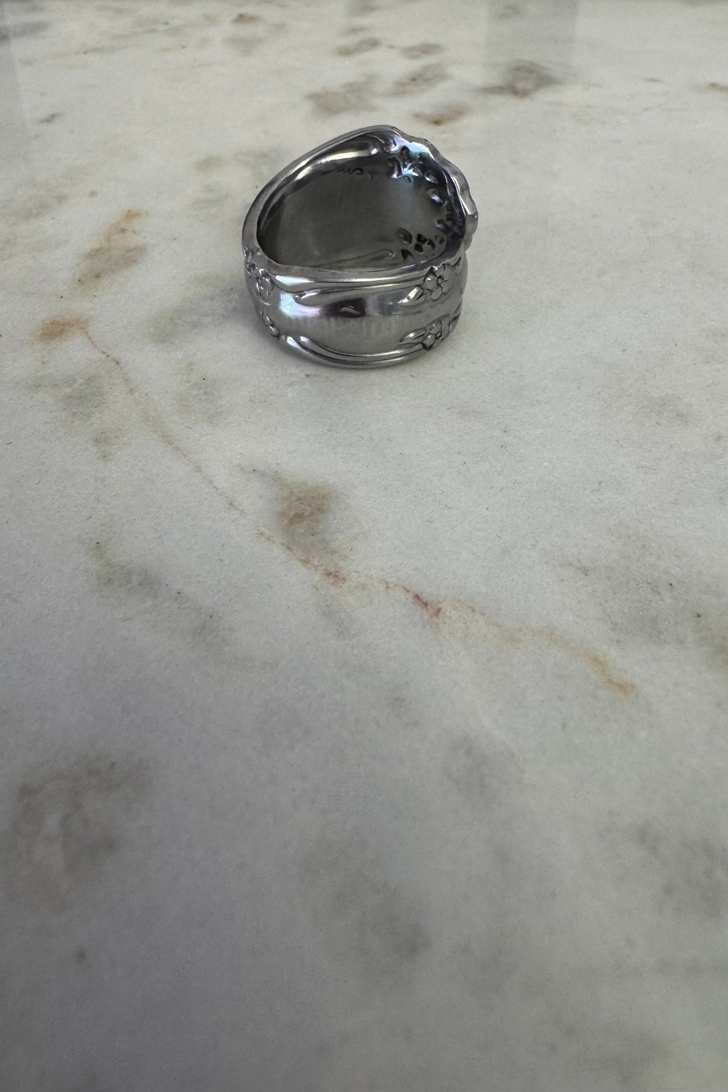 Silver ring on a marble surface