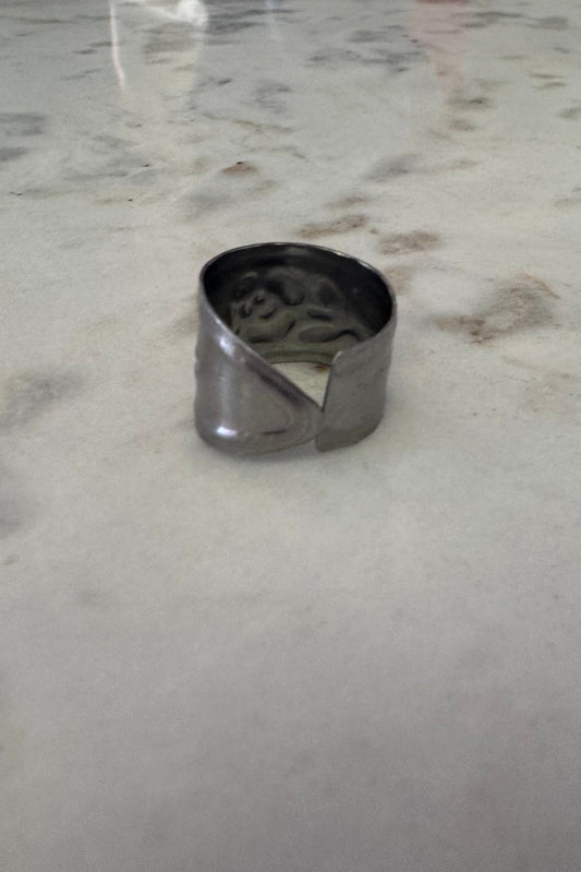 Silver ring on a marble surface