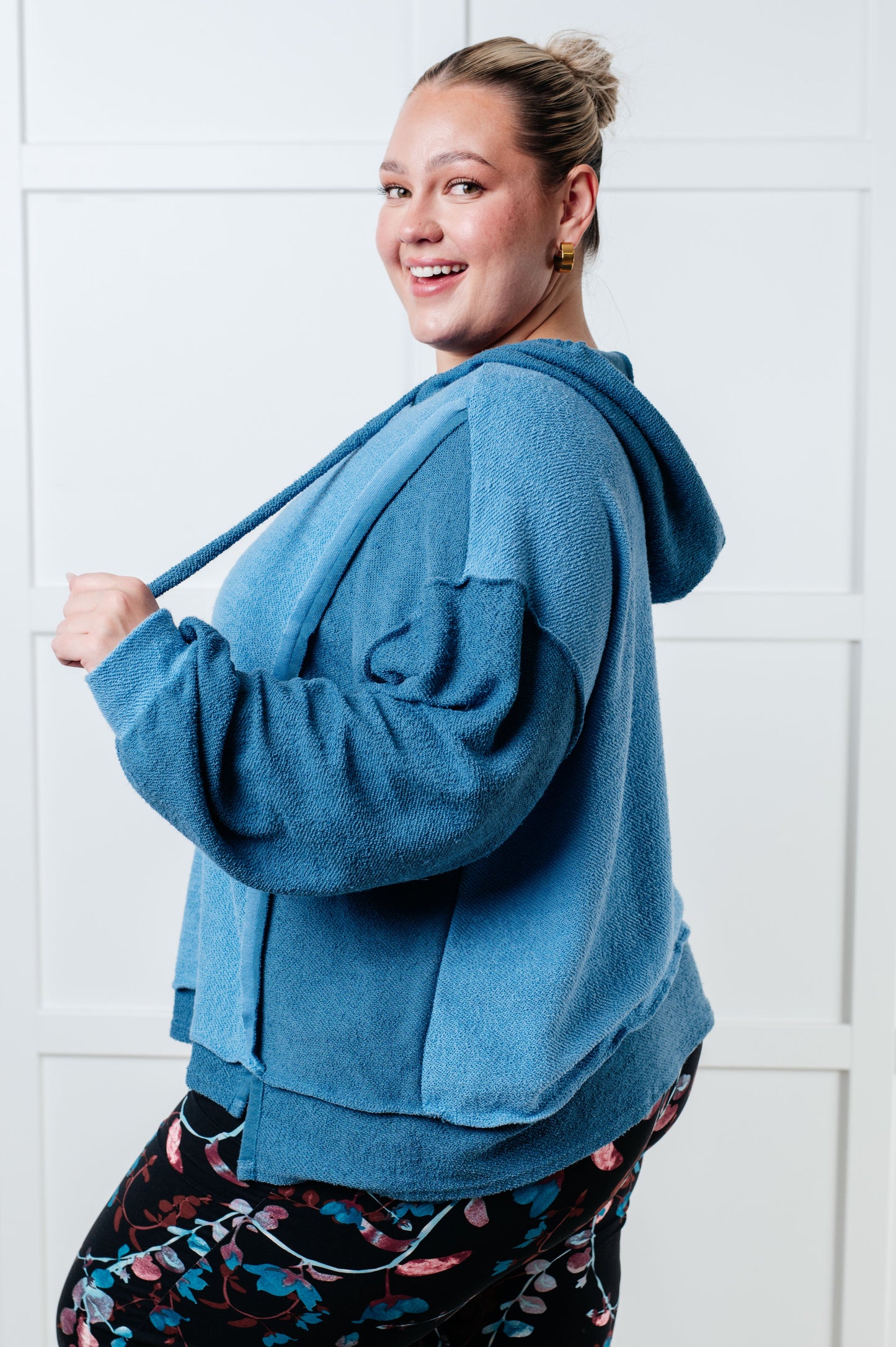 Person wearing a blue hoodie with a white background
