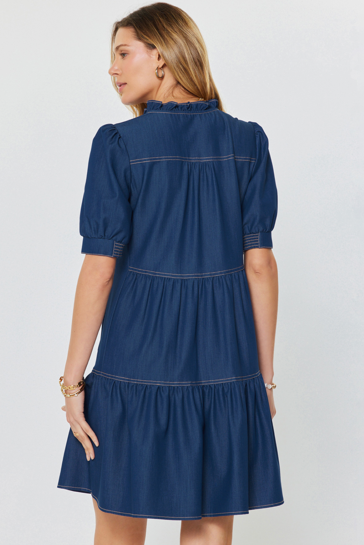Woman wearing a blue dress on a light gray background