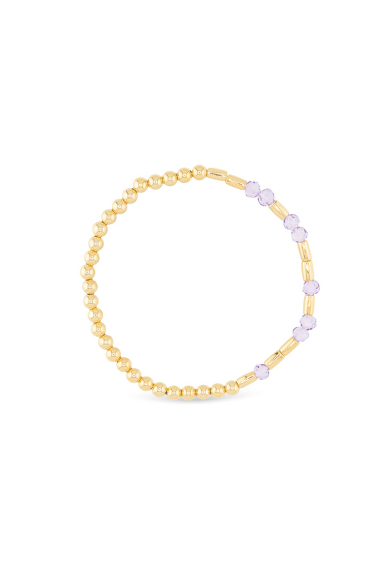 Gold bracelet with small beads on a white background