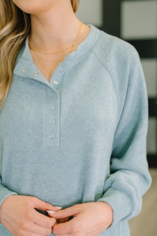 Light blue long-sleeve shirt worn by a person with a blurred background