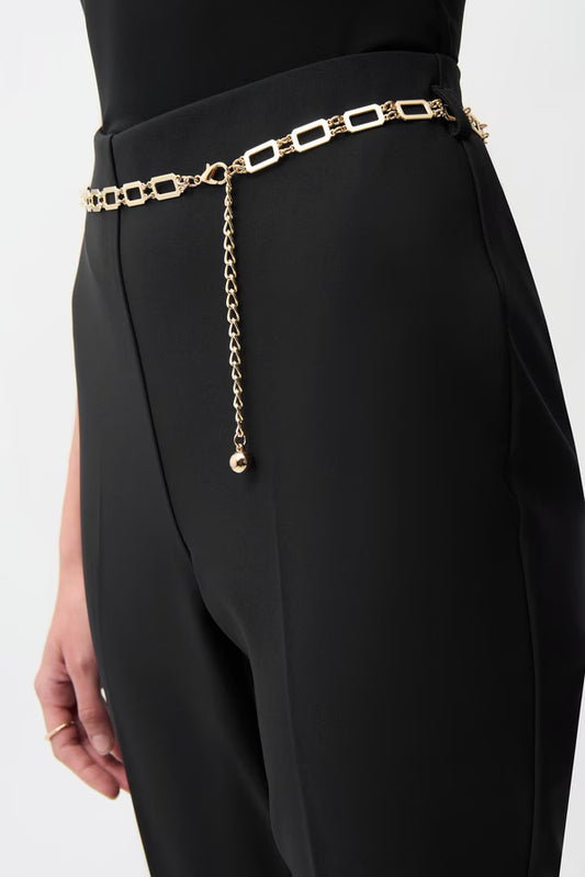 Black pants with a gold chain belt on a white background