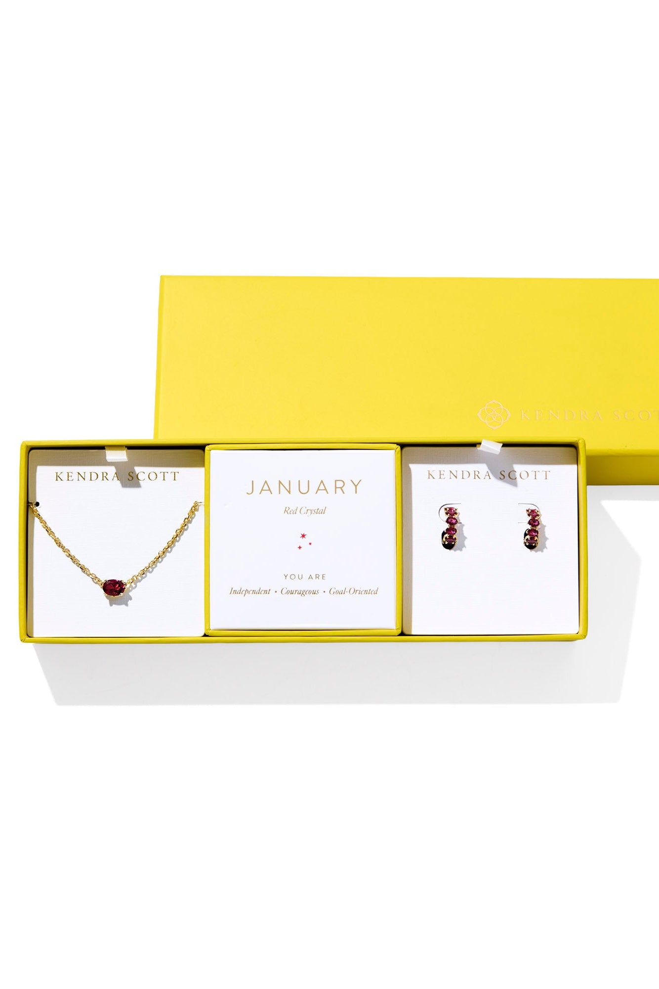 Jewelry set with necklace and earrings in a yellow box on a white background
