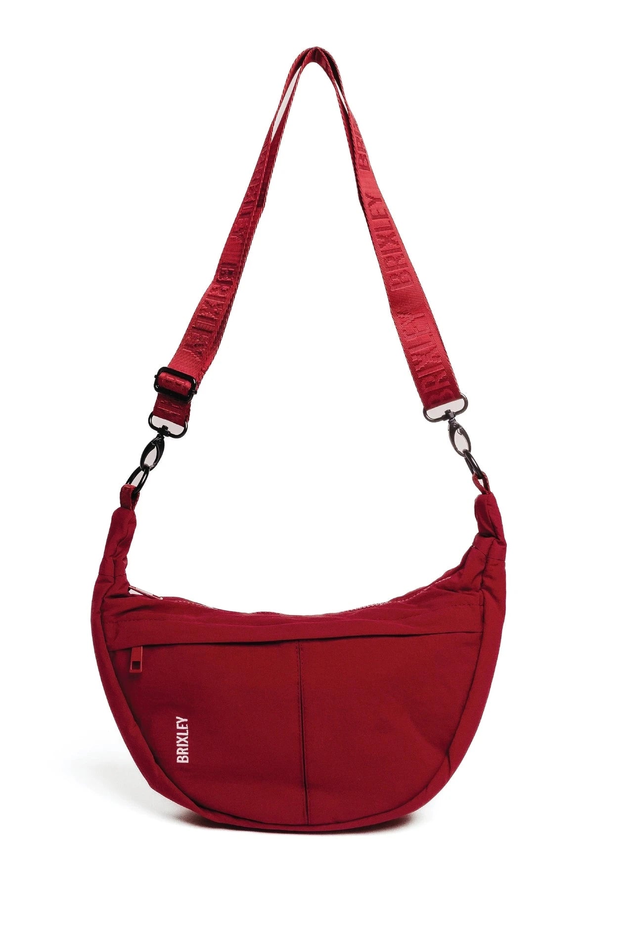 A red crescent-shaped shoulder bag with an adjustable, matching red webbed strap and silver-tone hardware, shown on a plain white background.