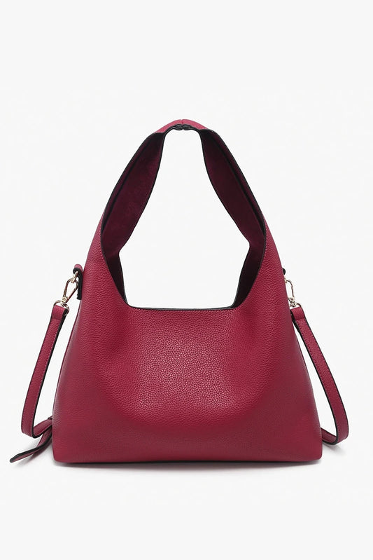 Red handbag with a strap on a white background