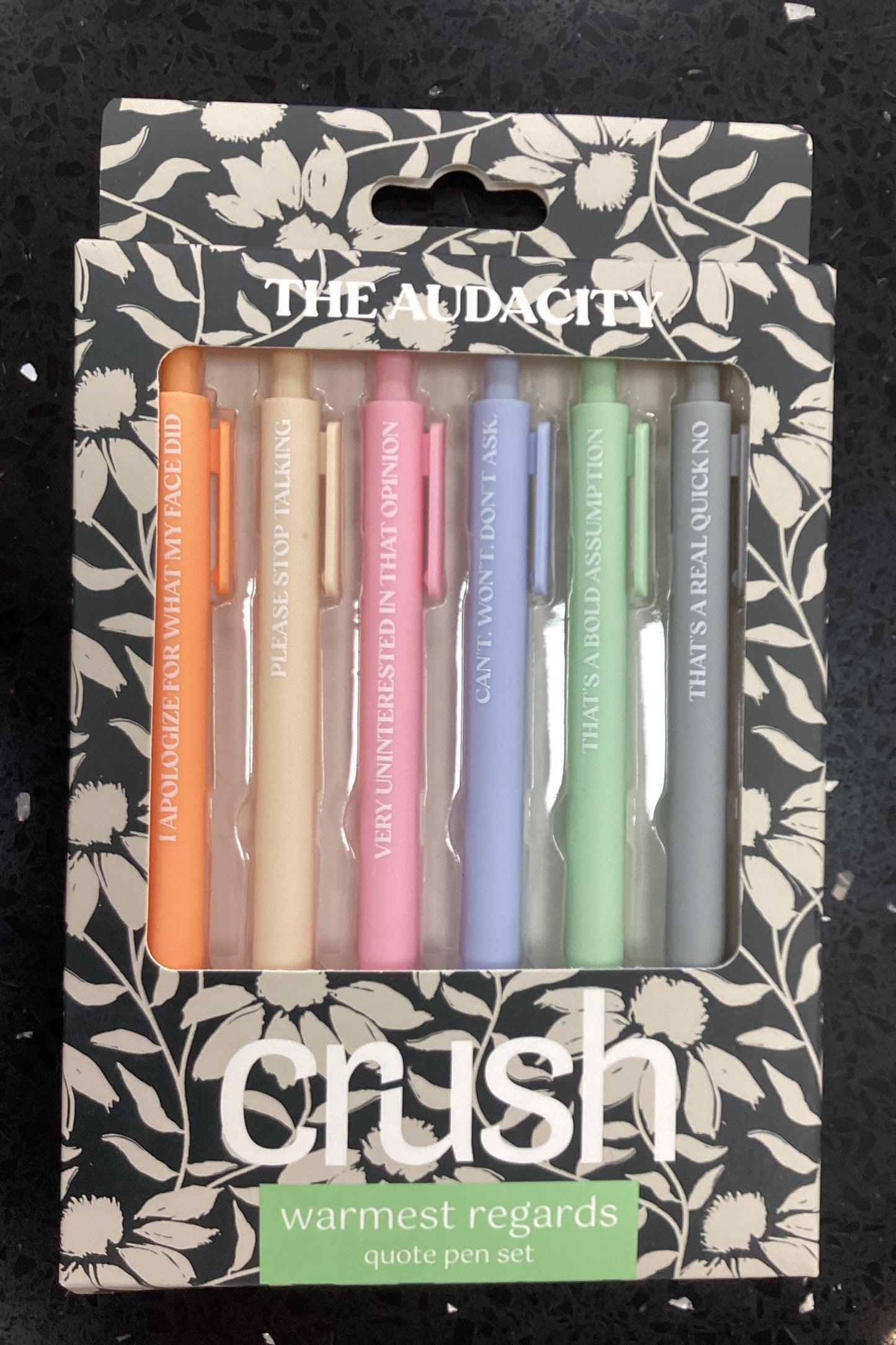 Set of colorful candles in a decorative box with 'Crush' branding on a black surface.