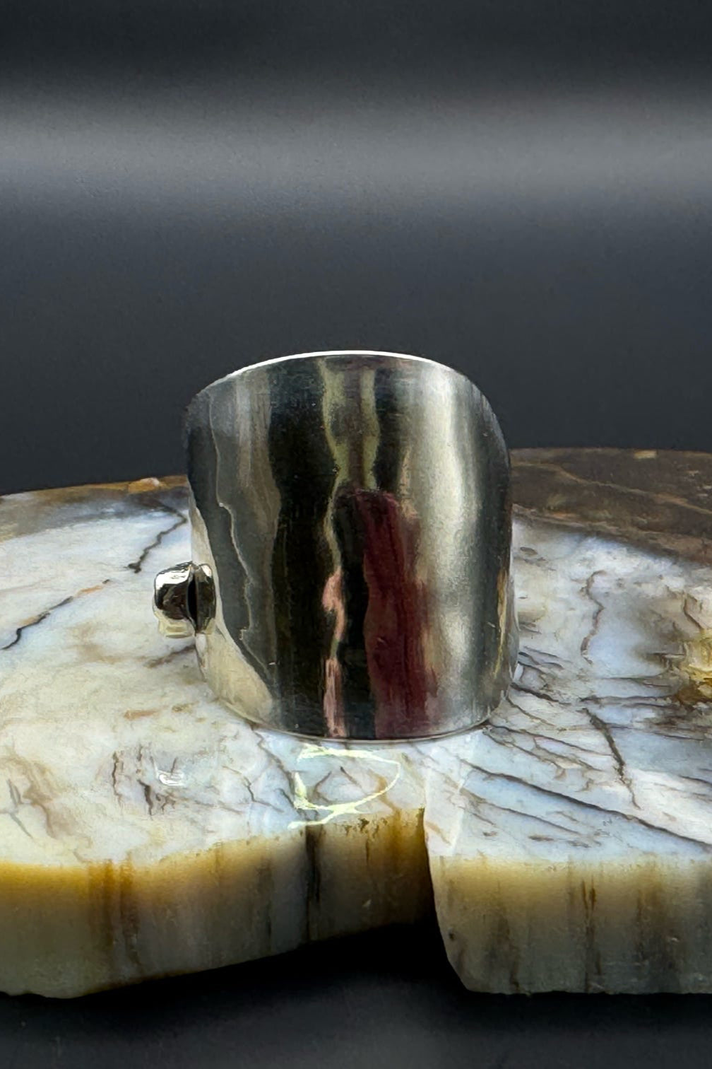 Silver ring with marble background