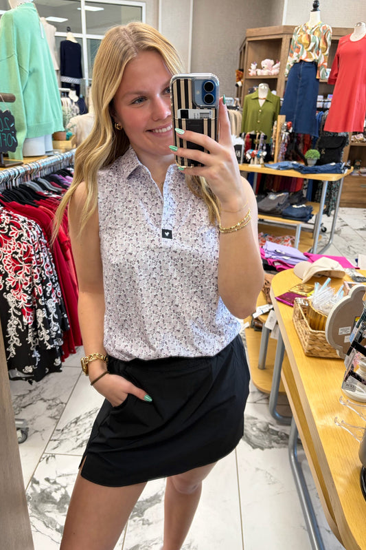 Woman taking a mirror selfie in a clothing store