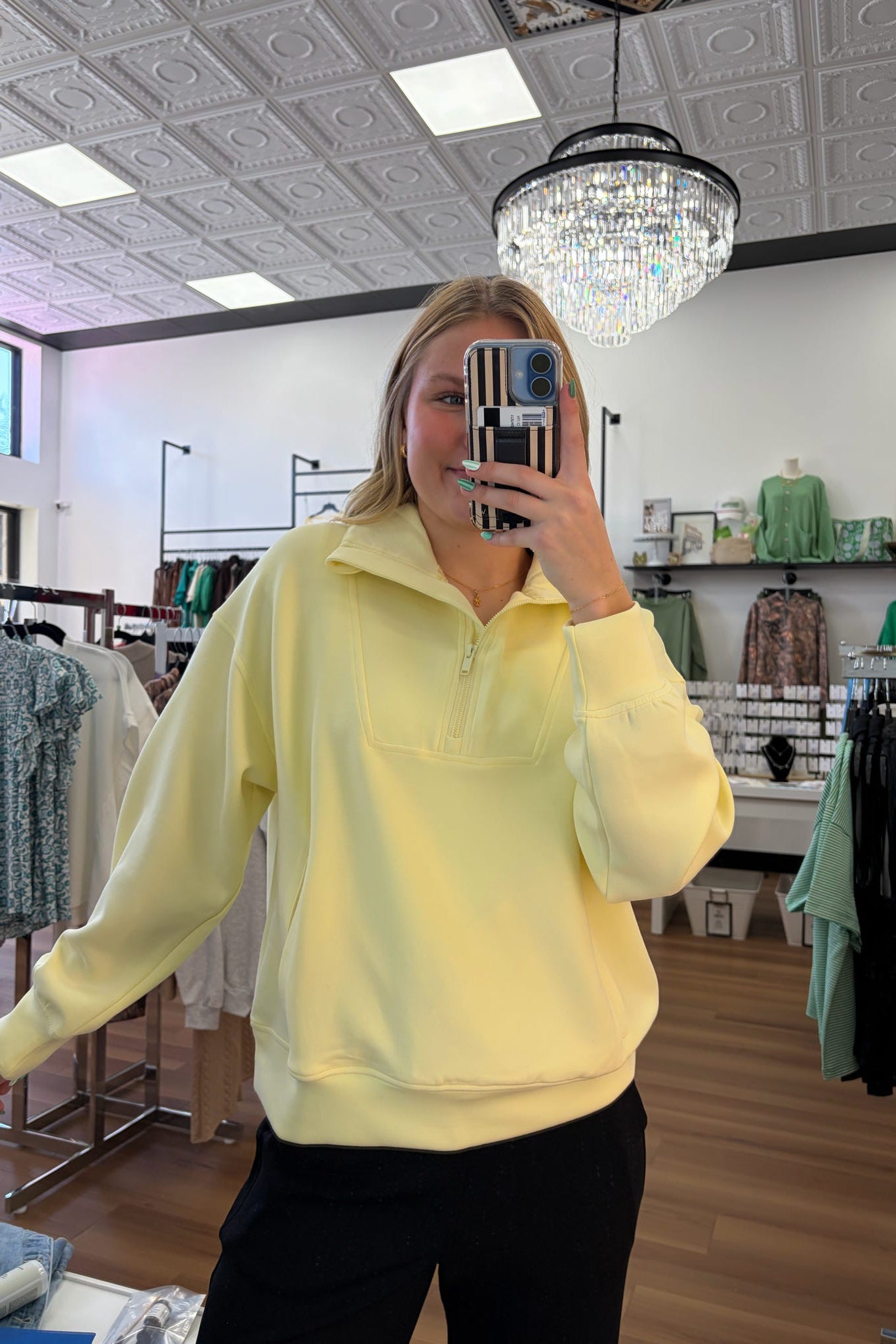 Person wearing a yellow sweatshirt in a store setting