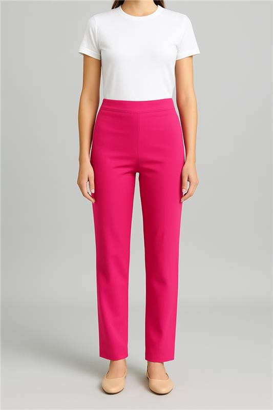 Person wearing a white top and bright pink pants on a gray background