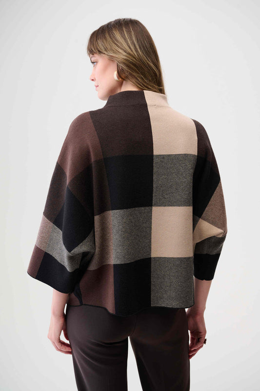 Woman wearing a checkered sweater with a neutral background