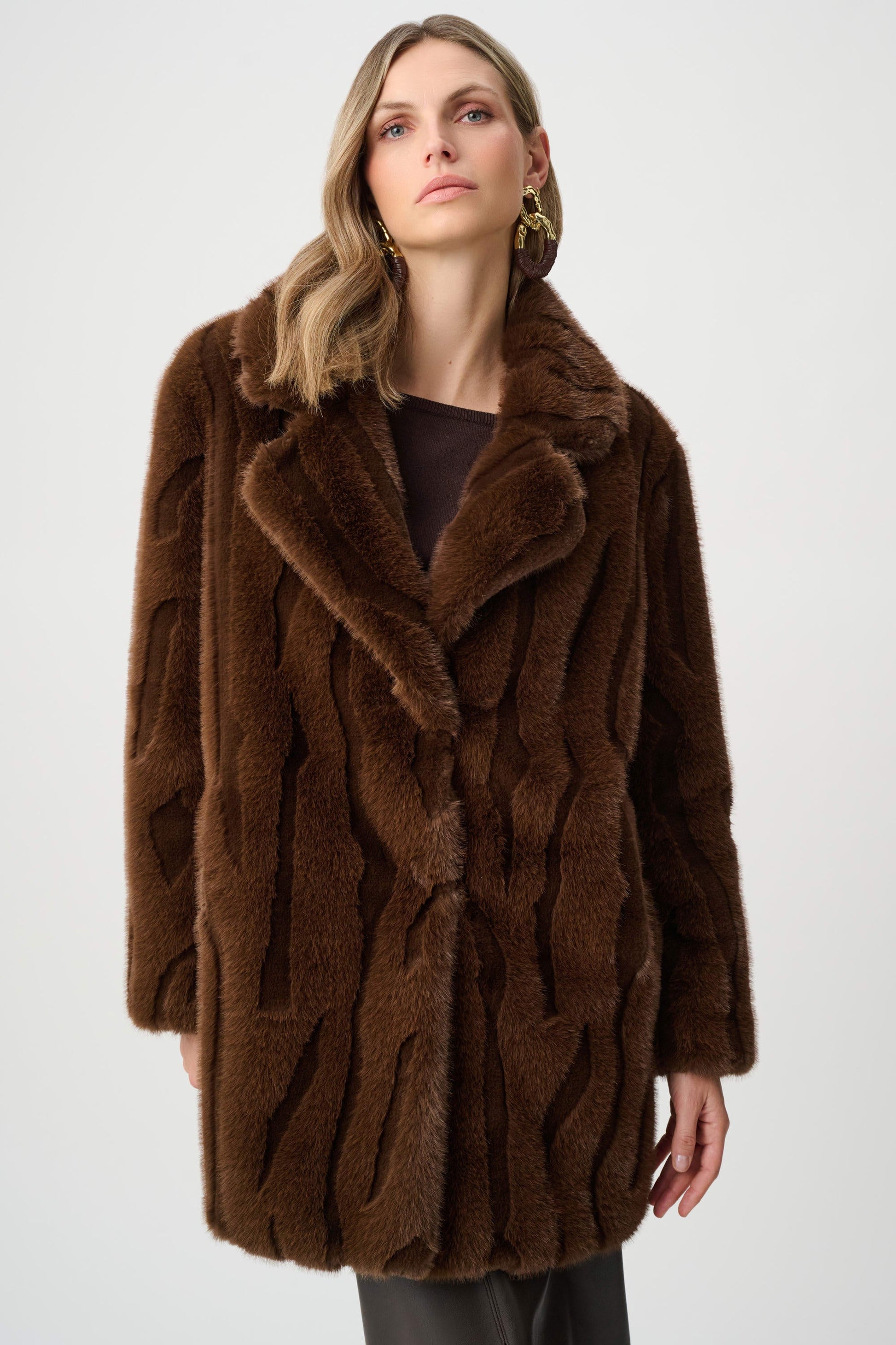 Woman wearing a brown fur coat on a white background