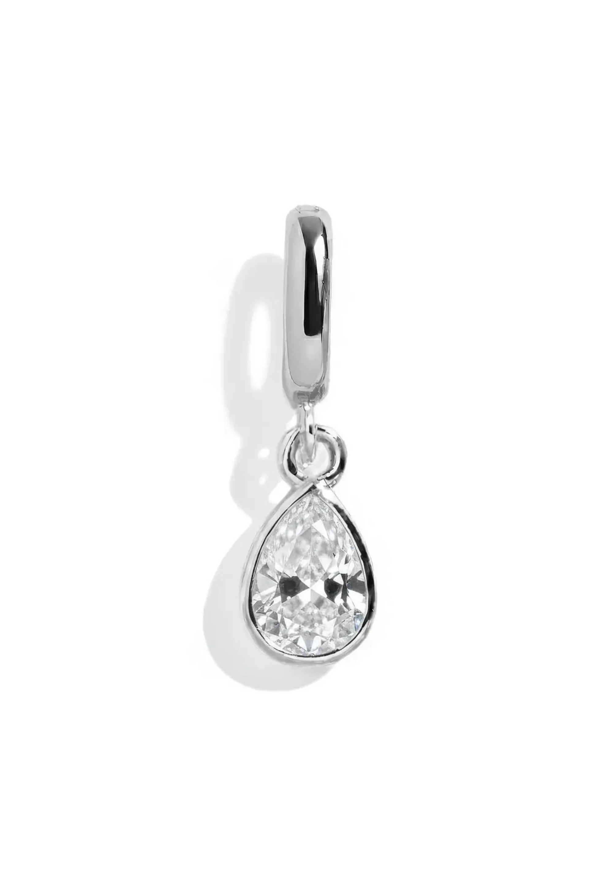 Silver teardrop-shaped pendant with a clear gemstone on a white background