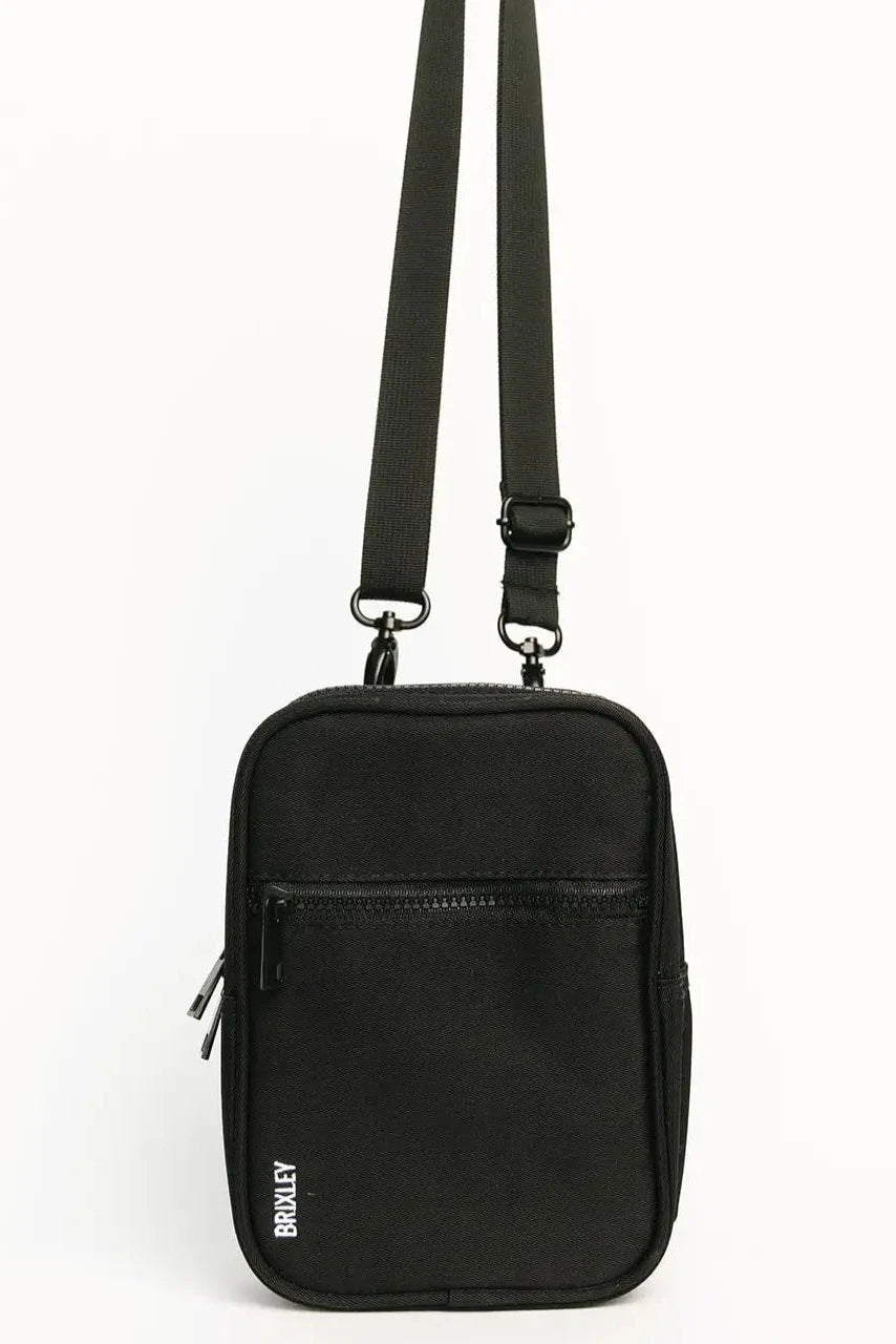 A black rectangular crossbody phone bag with a front zippered pocket and an adjustable shoulder strap, shown against a plain white background.