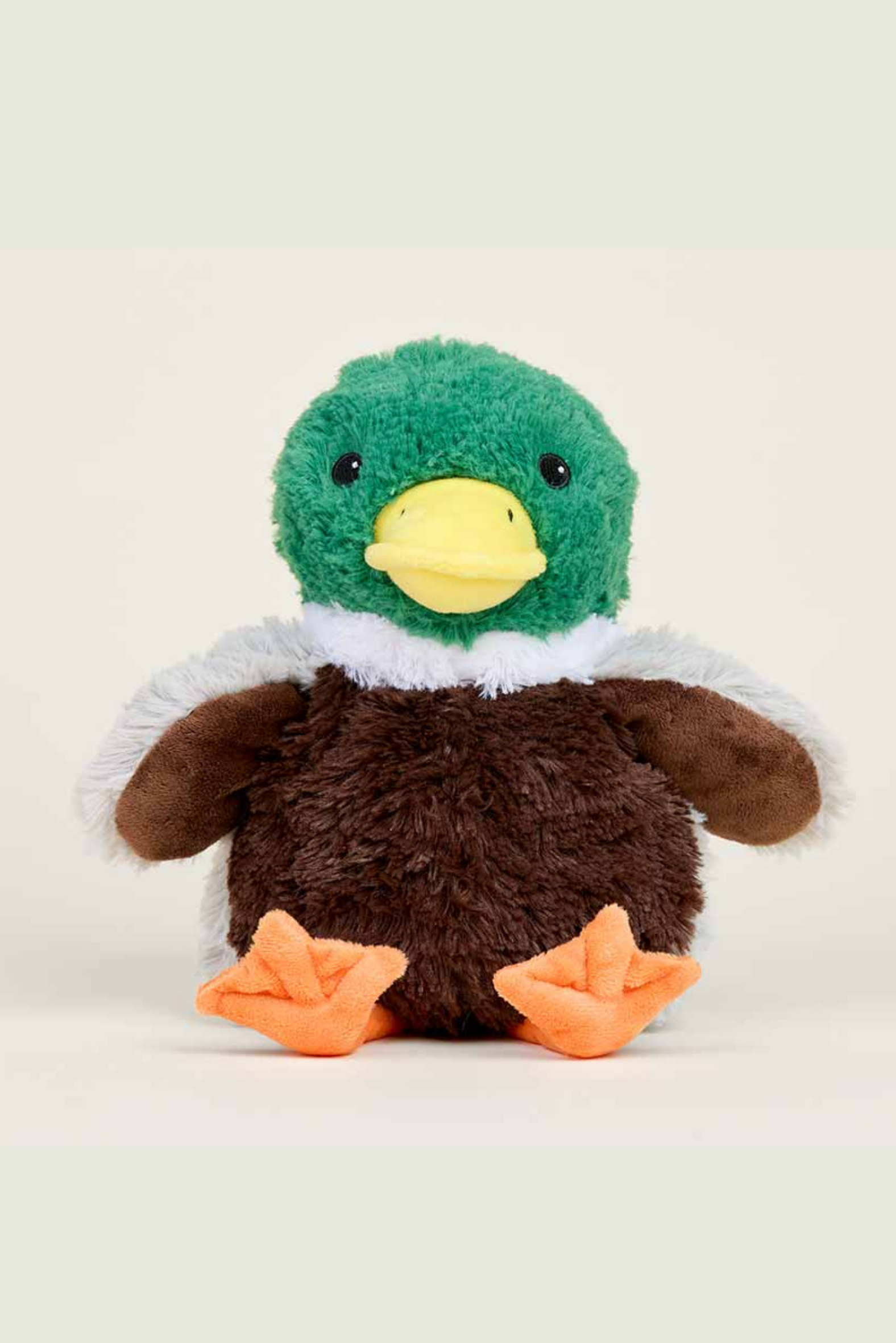 Plush toy eagle with green head, brown body, and orange feet on a light background