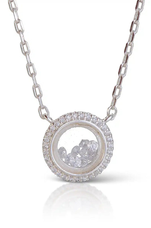 Silver necklace with a round pendant on a white background