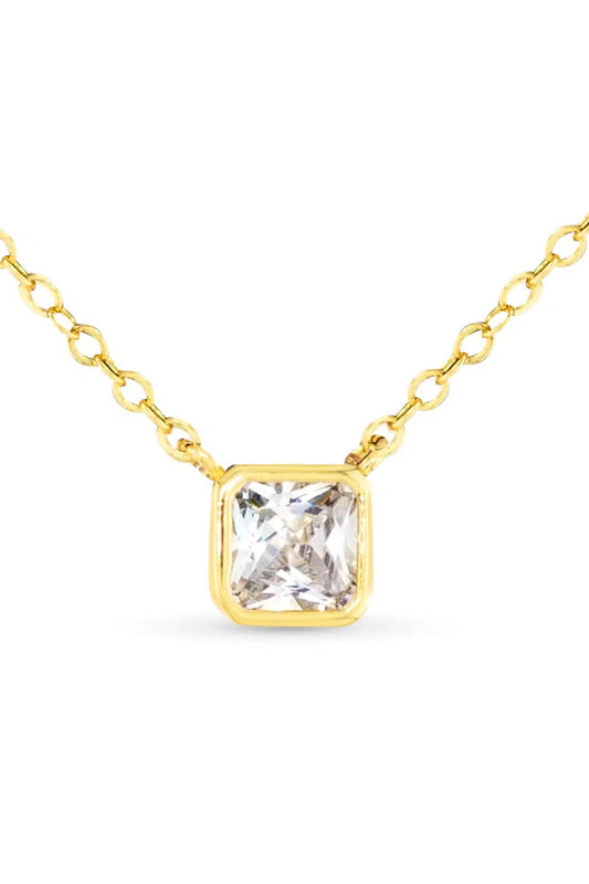 Gold necklace with a clear gemstone on a white background