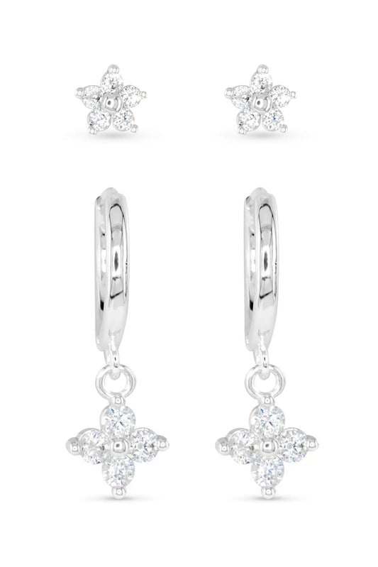 Silver earrings with star-shaped designs on a white background