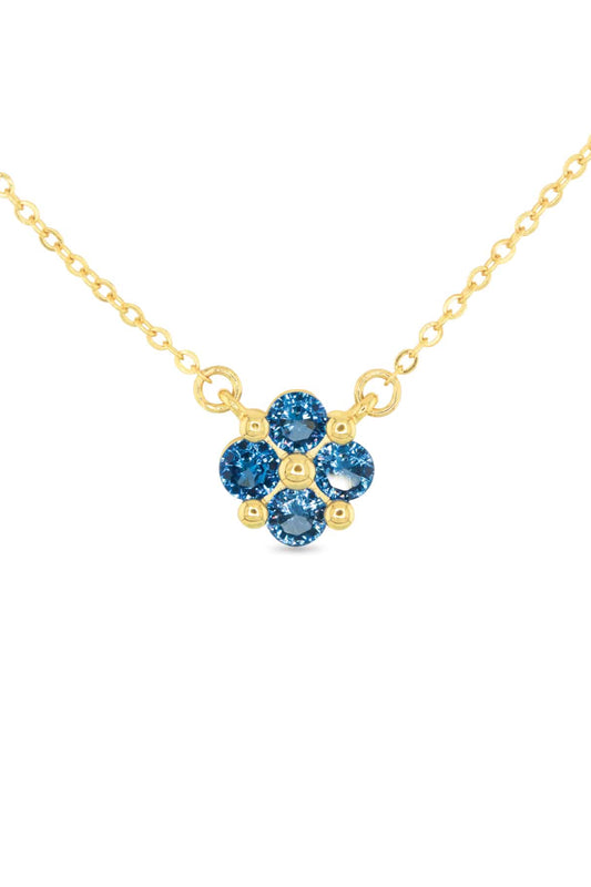 Gold necklace with blue gemstones on a white background