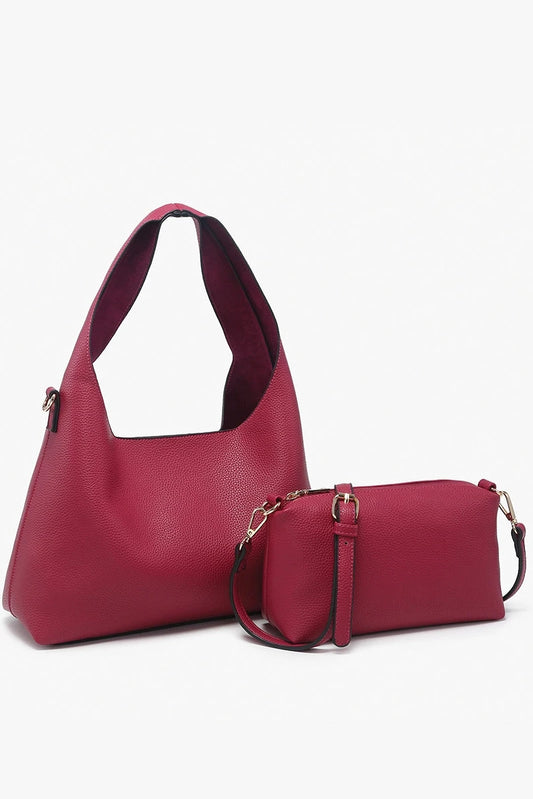 Red handbag with matching wallet on a white background