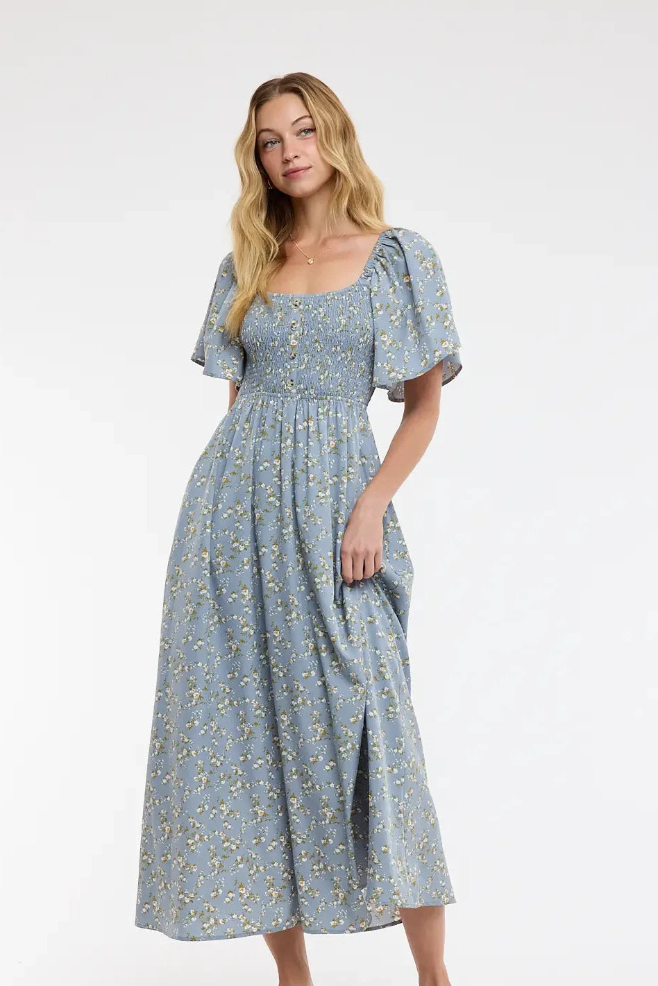 Woman wearing a blue floral dress on a white background