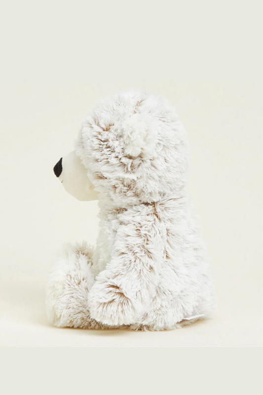 White fluffy teddy bear on a light beige background