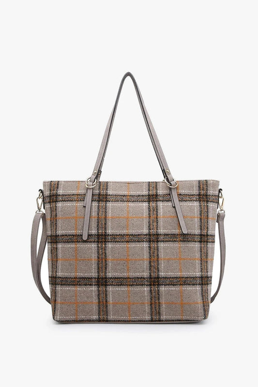 Plaid patterned handbag with shoulder straps on a white background