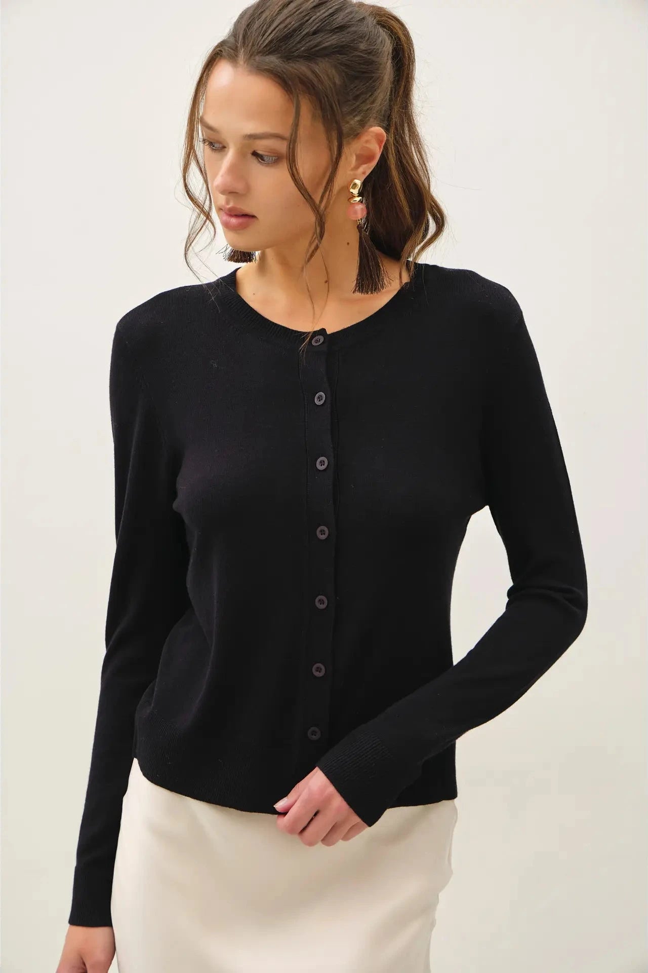black button up cardigan with a white background