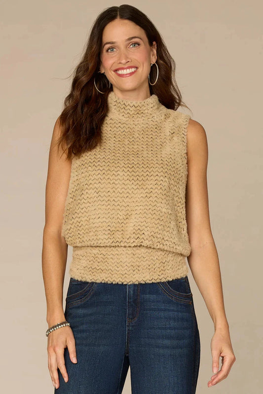 Woman wearing a beige knitted sleeveless top against a beige background