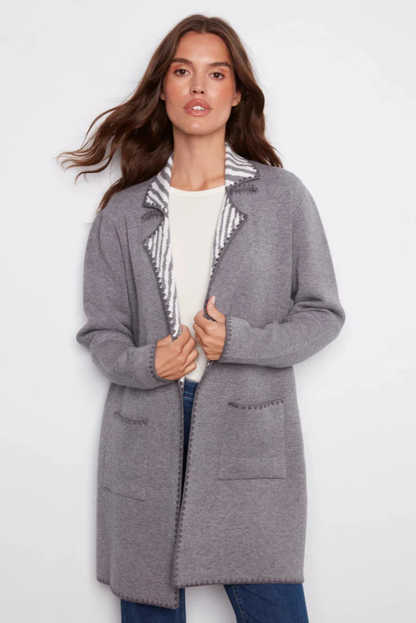 Woman wearing a gray coat with a white background
