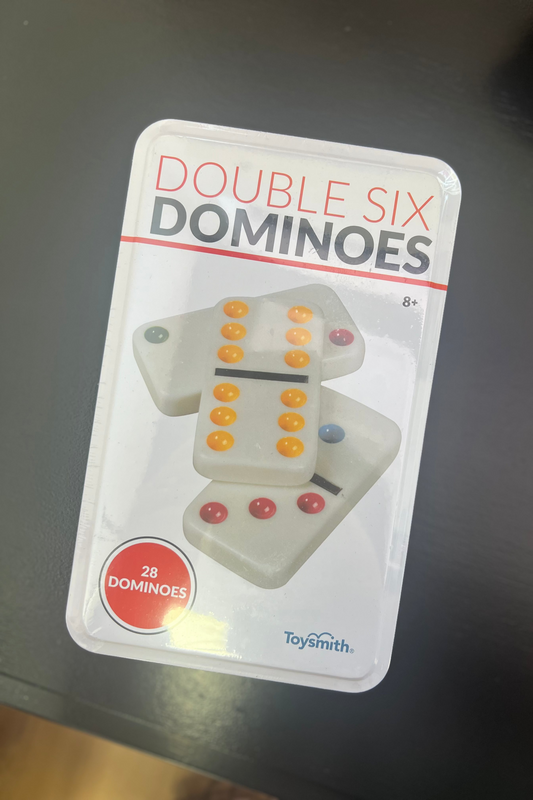 Double six dominoes packaging on a dark surface