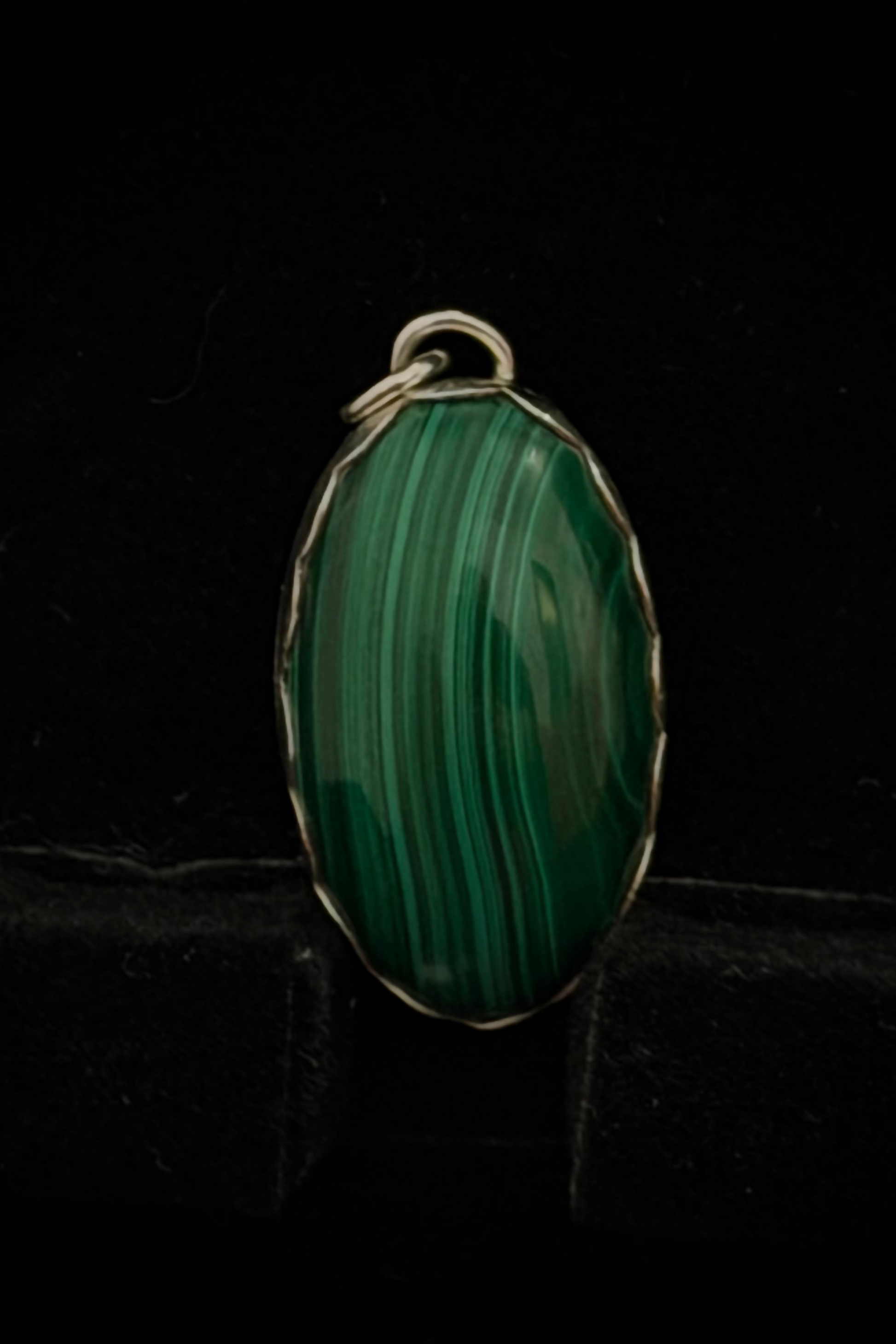 A pendant featuring a green malichite stone