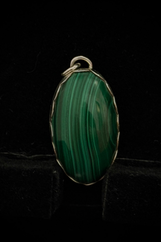 A pendant featuring a green malichite stone