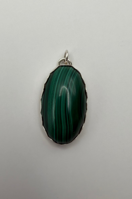 An oval green malachite stone pendant.